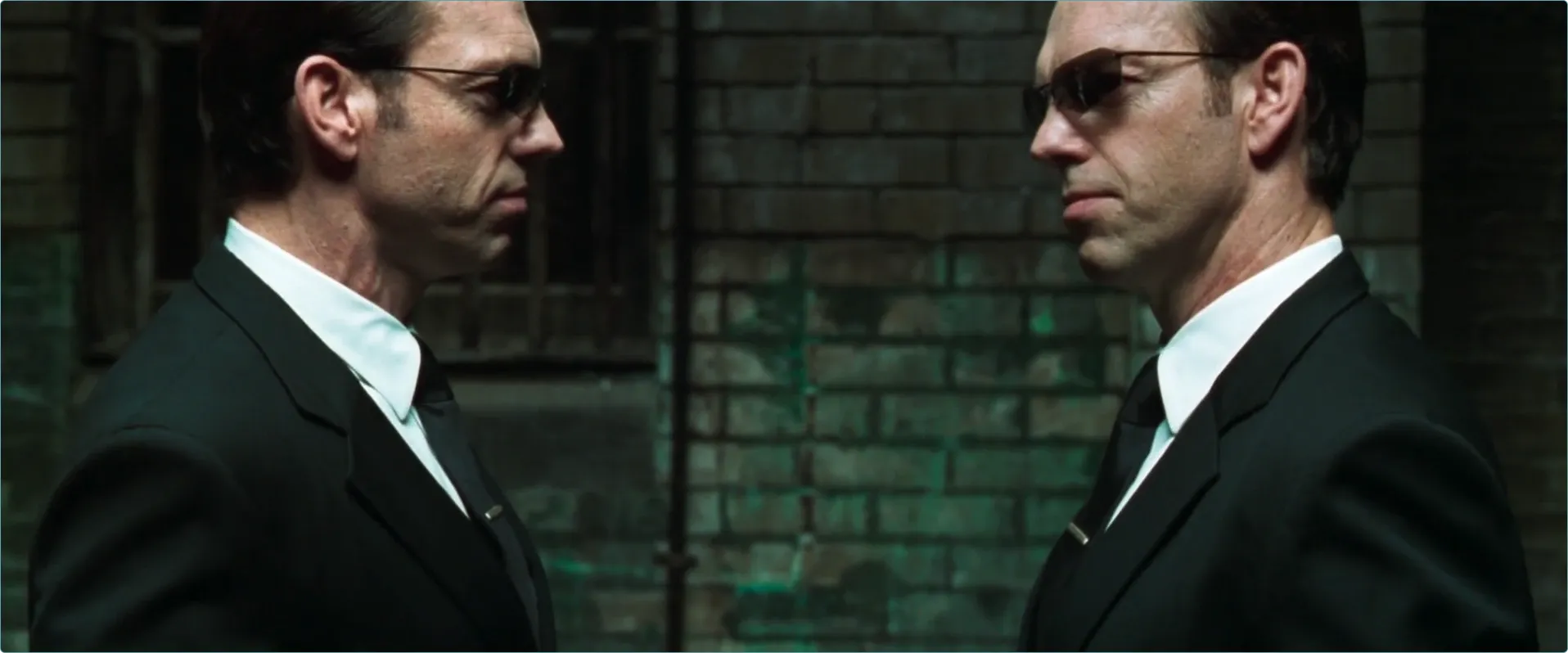 "An image of Agent Smith from the Matrix, facing himself"